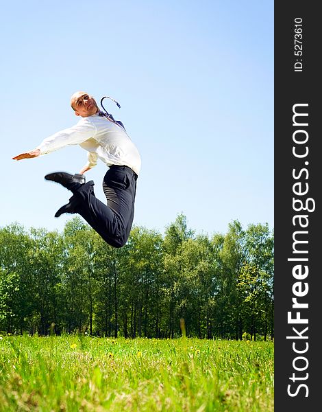 Jumping businessman in the park. Jumping businessman in the park.