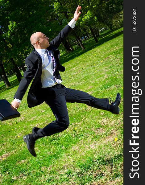 Jumping businessman in the park. Jumping businessman in the park.