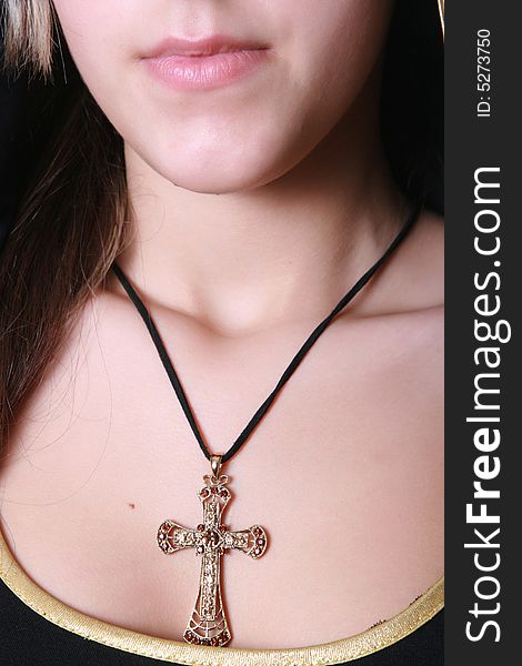 Beautiful precious cross on a breast at the girl