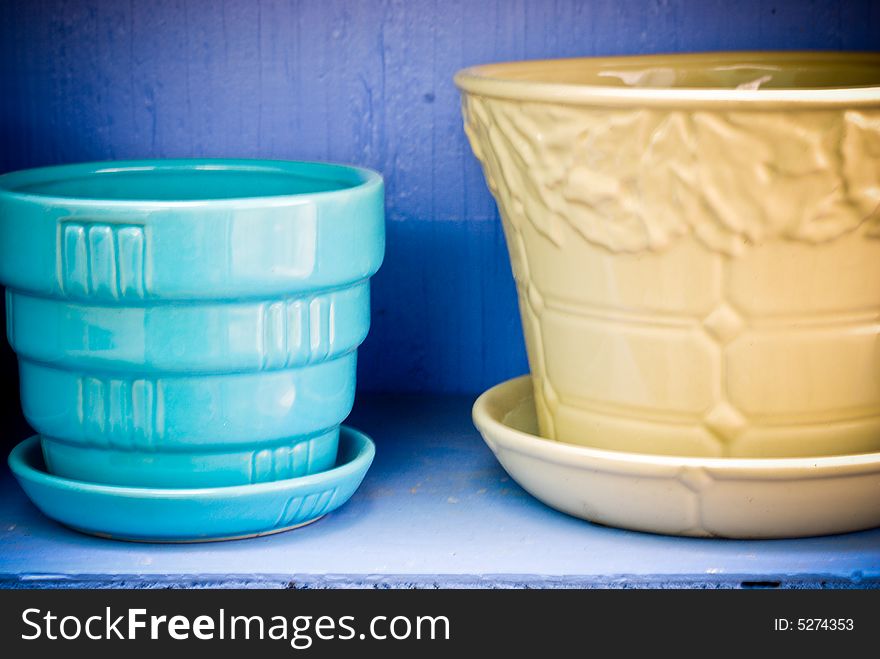 Blue & yellow flowerpots against a periwinkle background. Blue & yellow flowerpots against a periwinkle background.