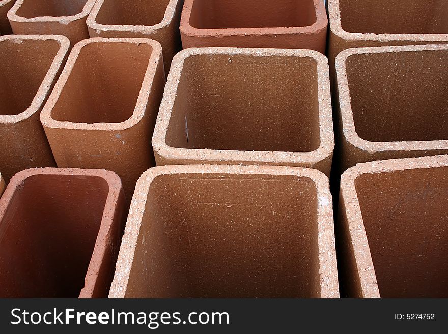 Close-up view of terra cotta chimney flues, useful for pattern, design, background for construction, hardware, masonry trades