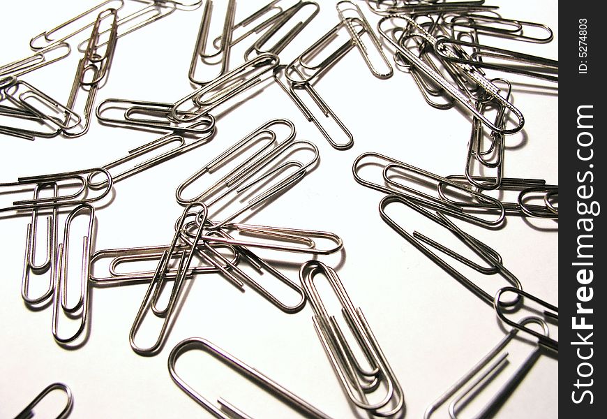 Paper clips scattered on the desk