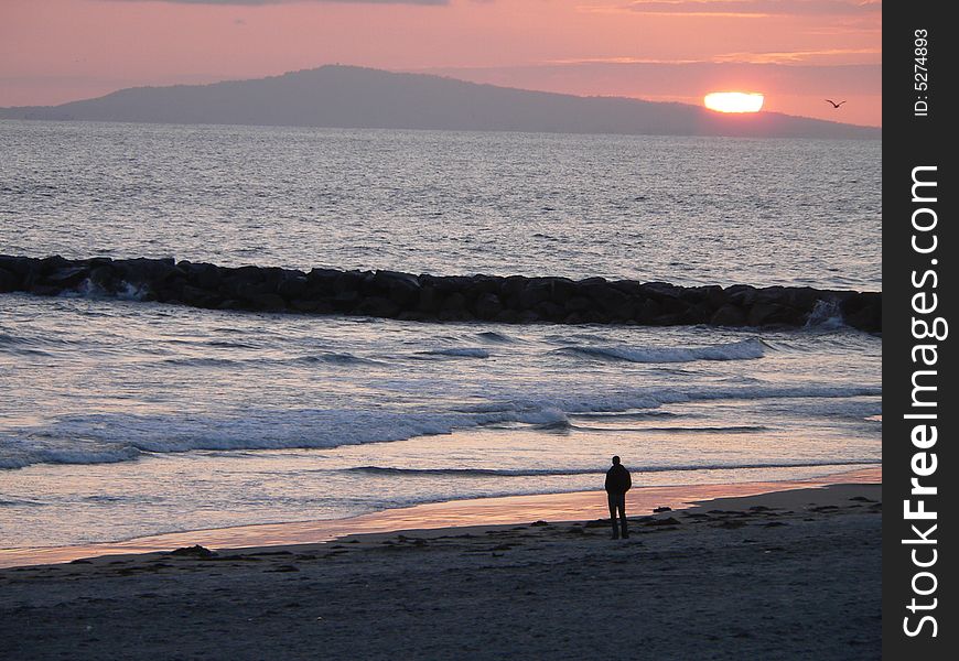 Sunset beyond Santa Catalina Island off the coast of Newport Beach - Landscape. Sunset beyond Santa Catalina Island off the coast of Newport Beach - Landscape