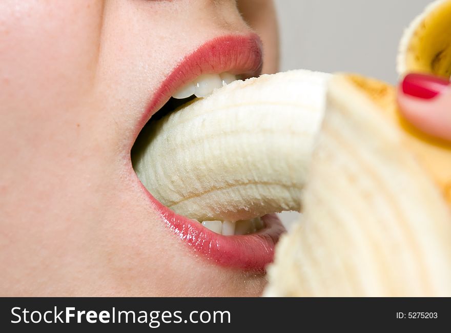 Girl eating banana closeup