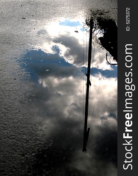 The sky reflected in water mirror. clouds after the storm. The sky reflected in water mirror. clouds after the storm