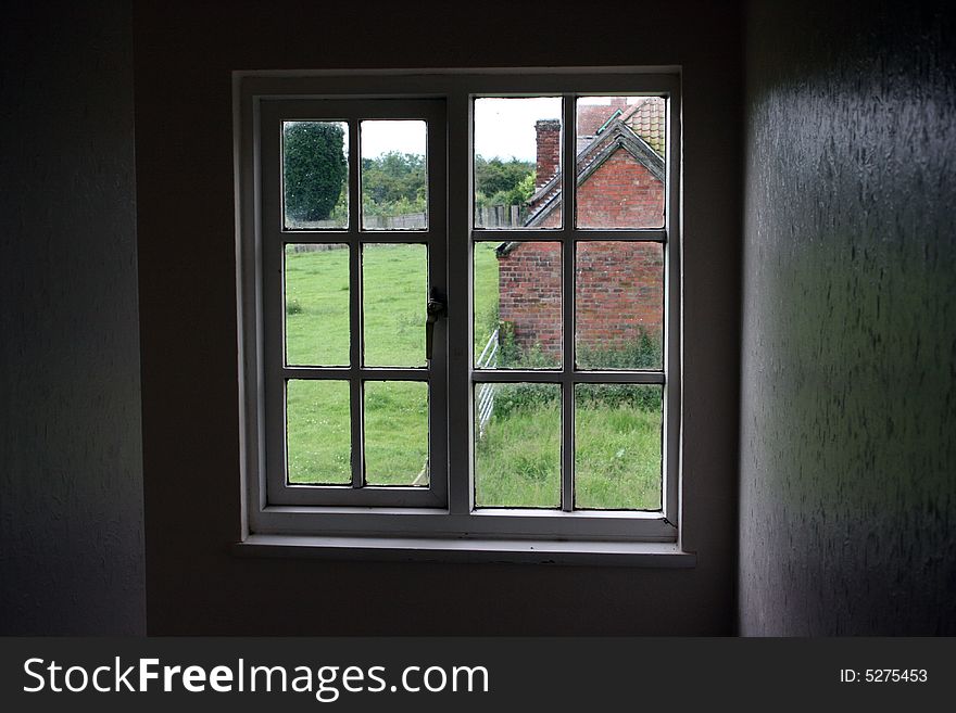 View from an English farmhouse window on a cloudy evening. View from an English farmhouse window on a cloudy evening