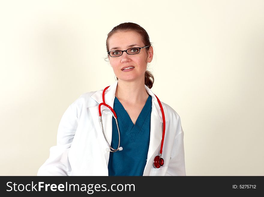 Cute brunette in white medical gown and a stethoscope in an hospital. Cute brunette in white medical gown and a stethoscope in an hospital