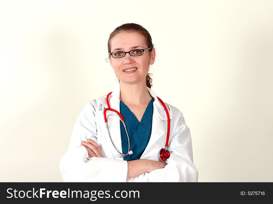 Cute brunette in white medical gown and a stethoscope in an hospital. Cute brunette in white medical gown and a stethoscope in an hospital