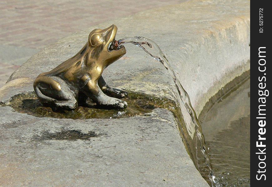 Frog fountain in a small plaza in a village in Corsica