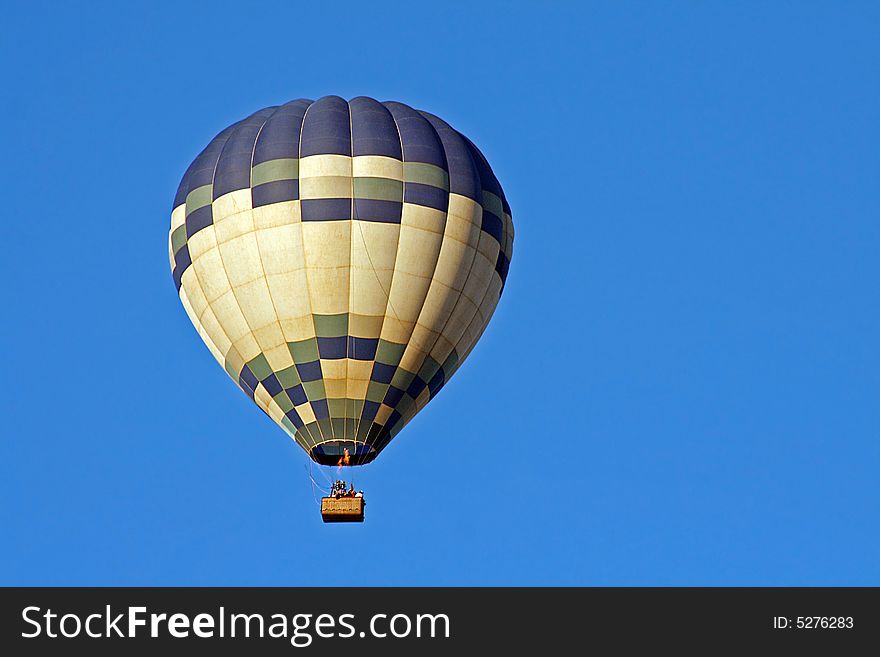 A Hot Air Balloon on an clear morning flight.  Space for copy.