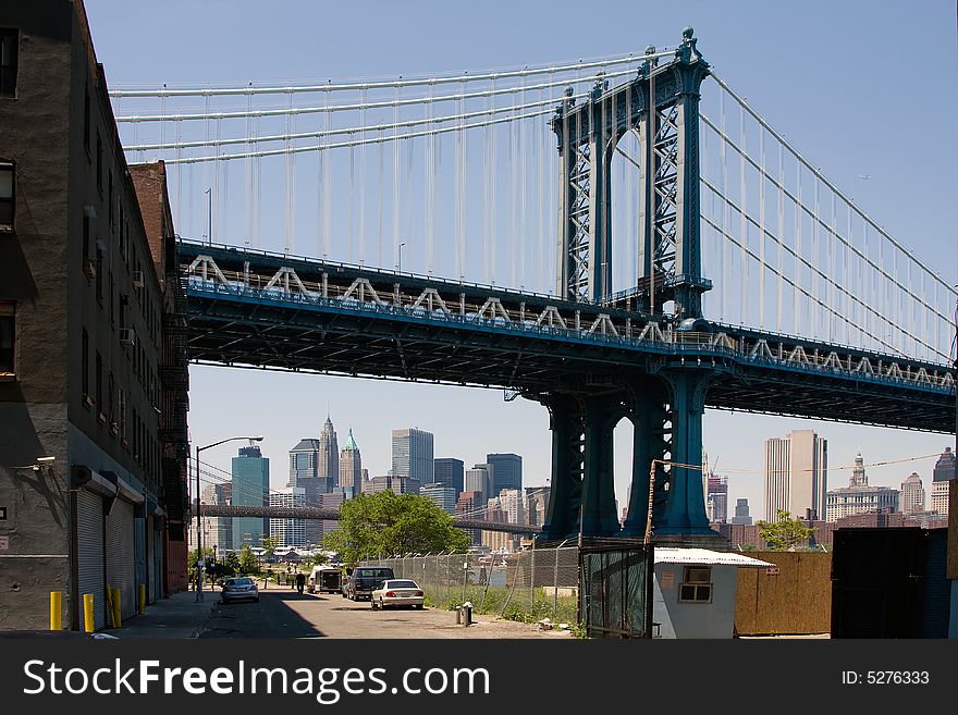 Manhattan Bridge as seen from DUMBO in Brooklyn. Looking at the skyline of Manhattan's financial district with the Brooklyn bridge in front as well.