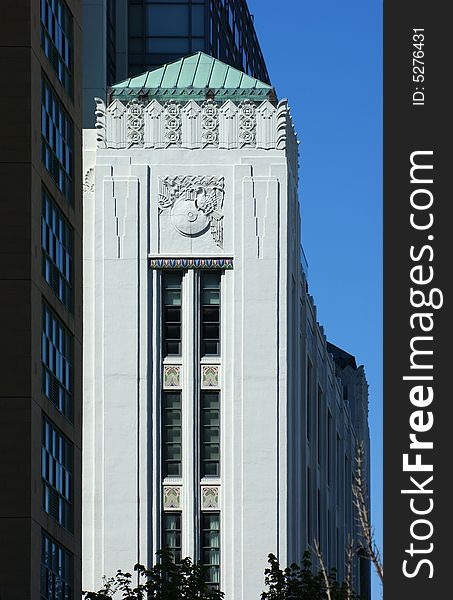 Art deco ornament along top of white wall in tower-like corner detail. Art deco ornament along top of white wall in tower-like corner detail