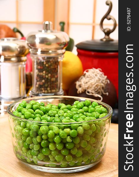 Bowl of fresh green peas in kitchen or restaurant.