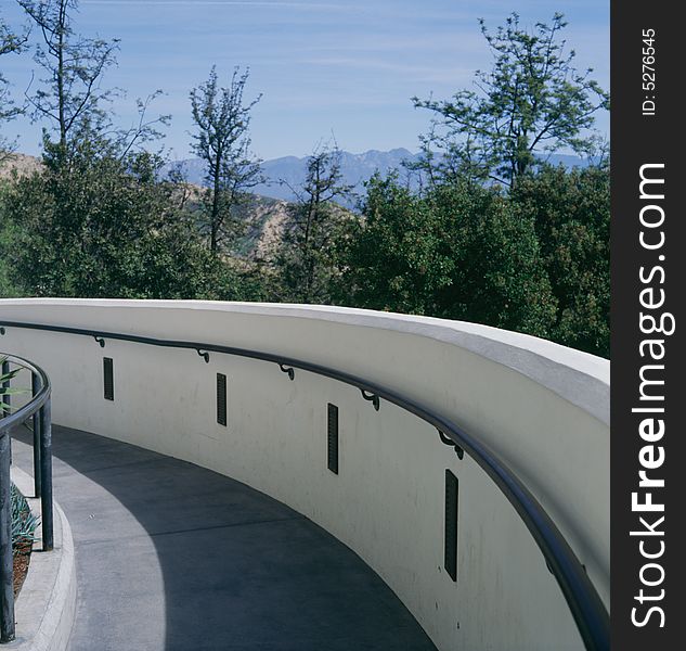 Curved walkway heading down with the view of mountains in the background