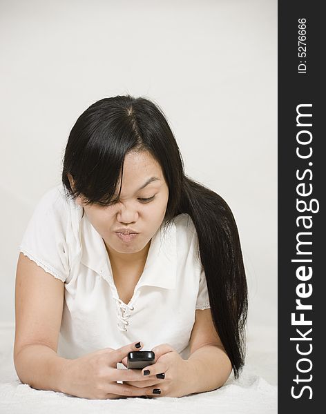 Asian woman texting on celphone