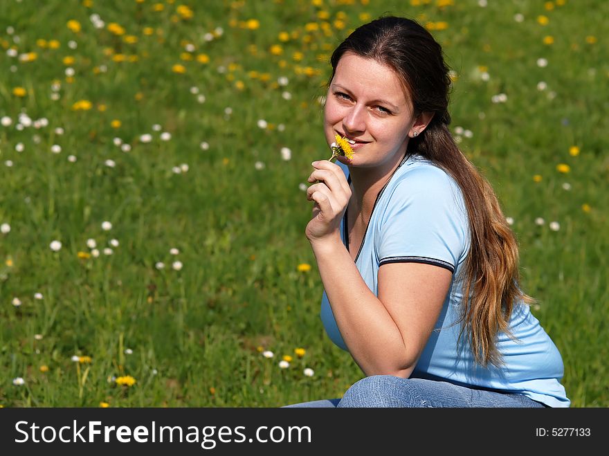 Young attractive female model enjoying flowers