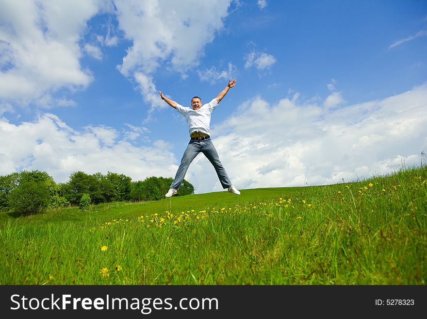 The man jumping on a lawn