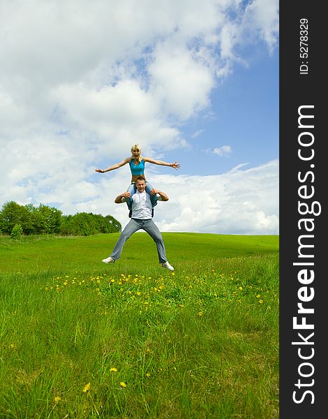 Young family jumping on a lawn