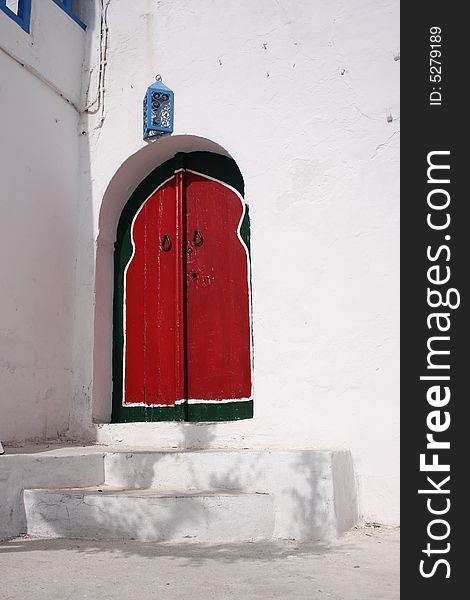 Picturesque red arabic door in Tunisia
