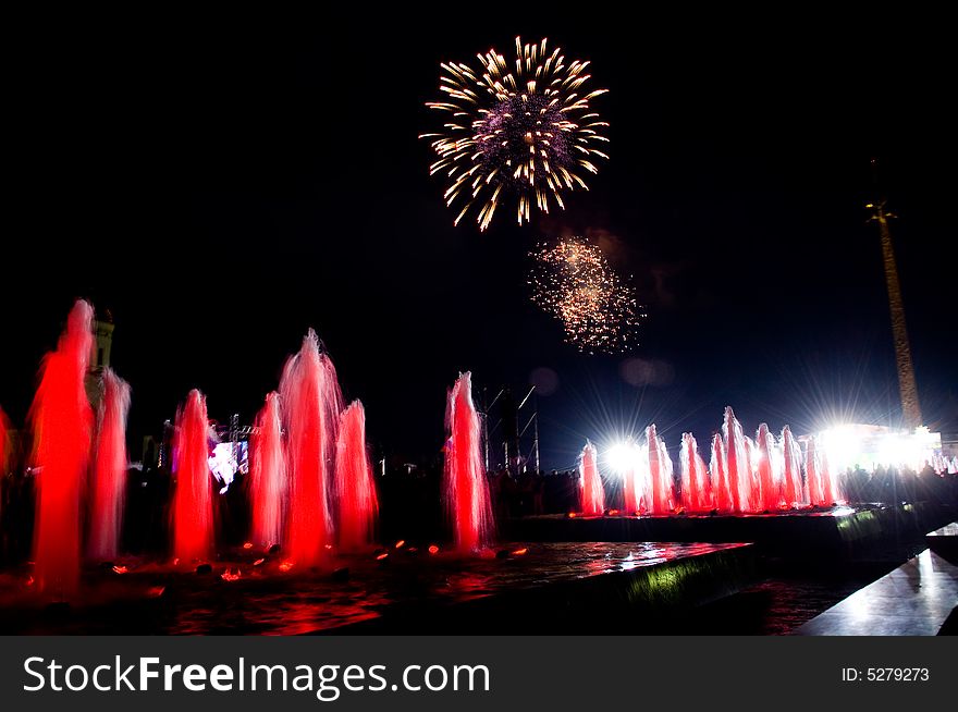 Beautiful fireworks over colored fountains. Beautiful fireworks over colored fountains