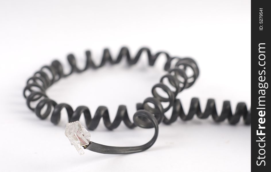 Black spiral phone cable at white background