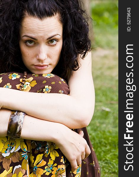 Young curly woman against green background. Young curly woman against green background