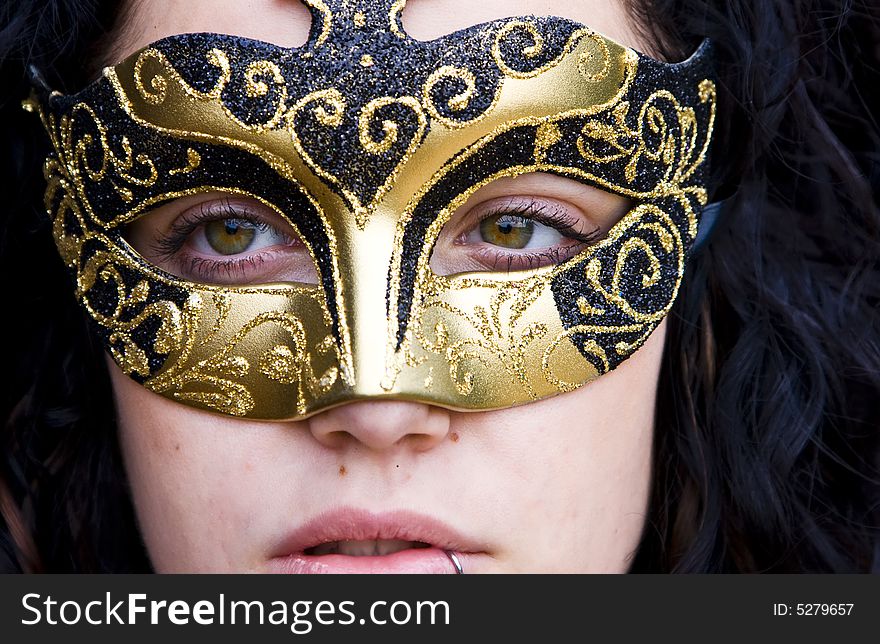 Masked curly woman, very close view. Masked curly woman, very close view