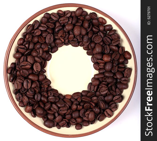 Saucer with coffee beans around