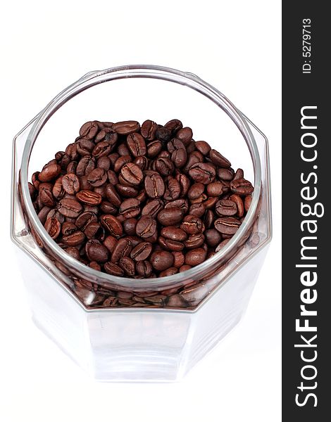 Coffee beans in a glass-jar above. Coffee beans in a glass-jar above