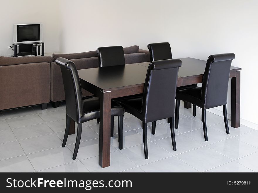 TV In Modern Living Room - White Tiles, Dark Chairs, Table, Sofa