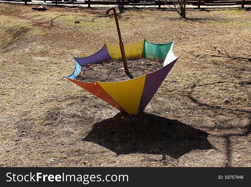 Flower bed in the form of an umbrella in the early spring in the Saratov city park. Flower bed in the form of an umbrella in the early spring in the Saratov city park