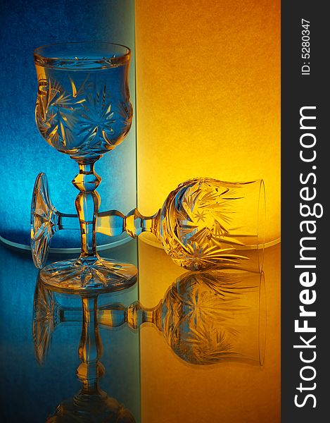Two glasses on yellow-blue background