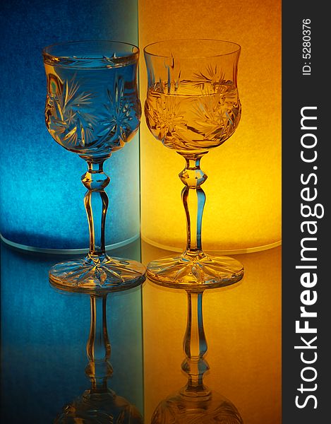 Two glasses on yellow-blue background
