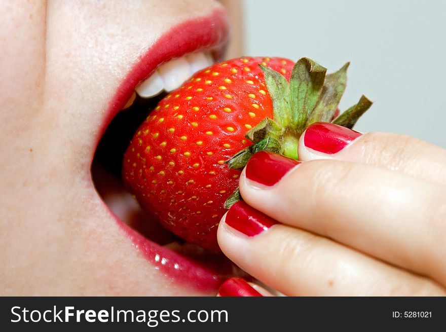 A girl, eating a strawberry, in macro mode. A girl, eating a strawberry, in macro mode