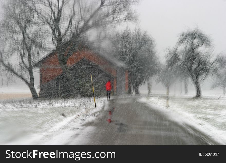 Driving on a narrow road in snowfall, jogger in signal colored dress. Driving on a narrow road in snowfall, jogger in signal colored dress