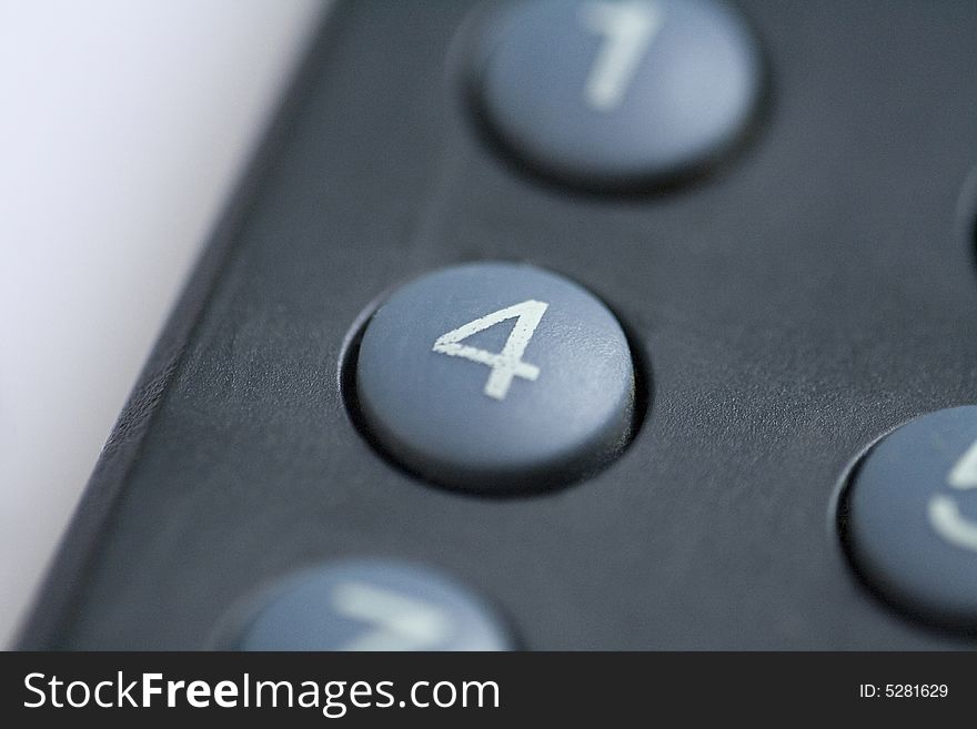 A close up of a number four button on a remote control