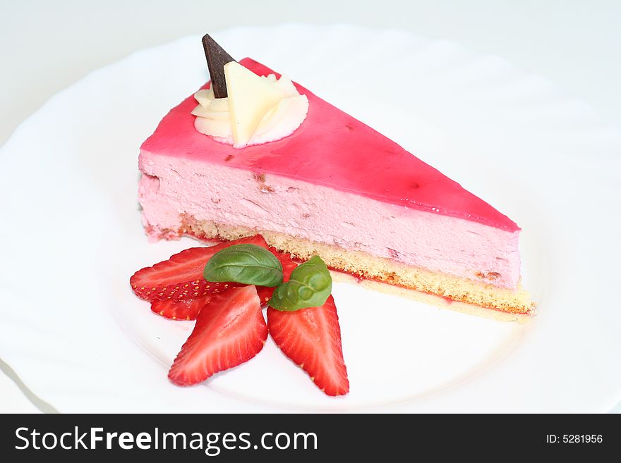 Slice of cheesecake with strawberry topping, selective focus, flash. Slice of cheesecake with strawberry topping, selective focus, flash