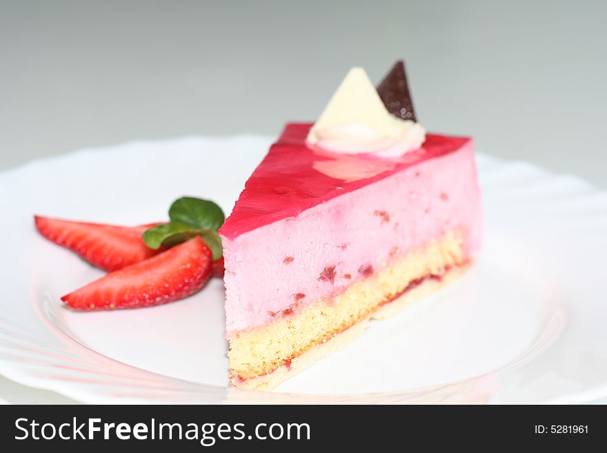 Slice of  cake with strawberry, selective focus, flash. Slice of  cake with strawberry, selective focus, flash