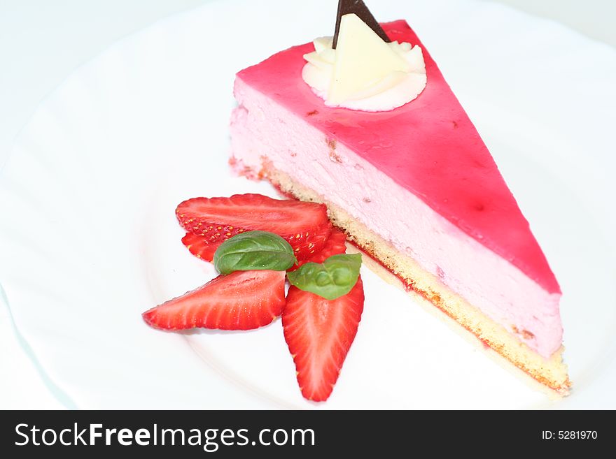 Slice of  cake with strawberry, selective focus, flash. Slice of  cake with strawberry, selective focus, flash