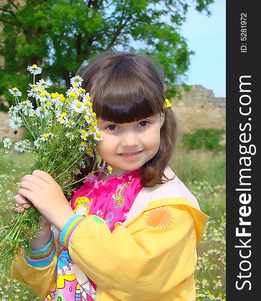 Pretty girl of preschool age with the bouquet of chamomiles. Pretty girl of preschool age with the bouquet of chamomiles.