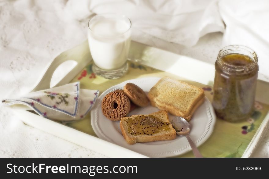 Breakfast served in bed, on the tray bread. biscuits, jam and milk. Breakfast served in bed, on the tray bread. biscuits, jam and milk