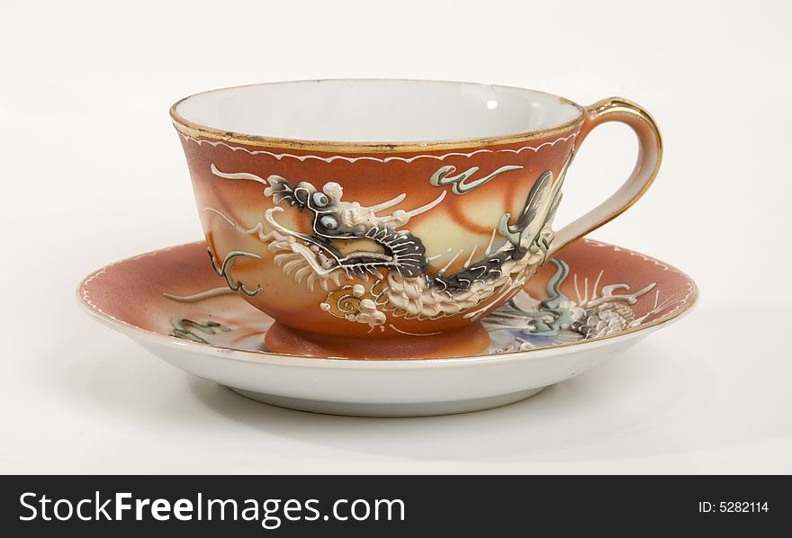A unique tea cup with dragon design. A unique tea cup with dragon design