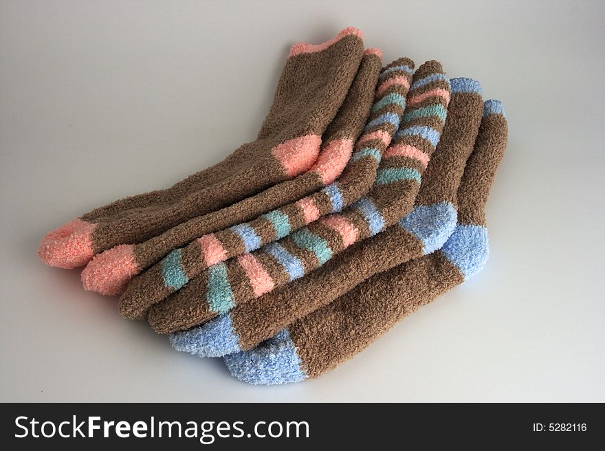 Three pairs of colorful socks stacked. Three pairs of colorful socks stacked.