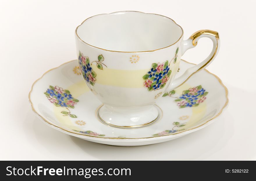 An antique tea cup with gold detail. An antique tea cup with gold detail