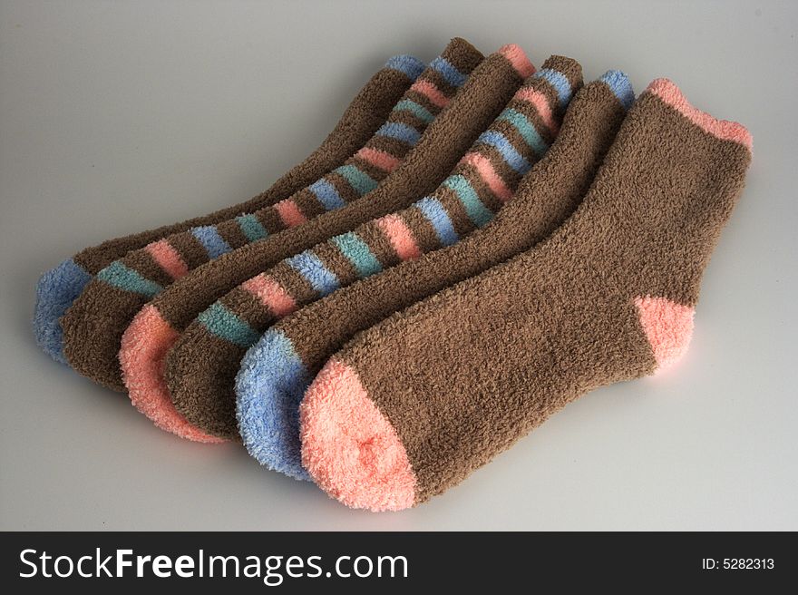 Three pairs of colorful socks stacked. Three pairs of colorful socks stacked.