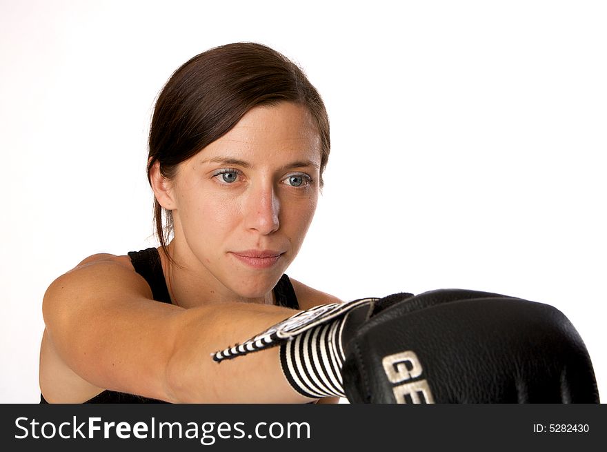 Woman in gym clothes, with boxing gloves, strength