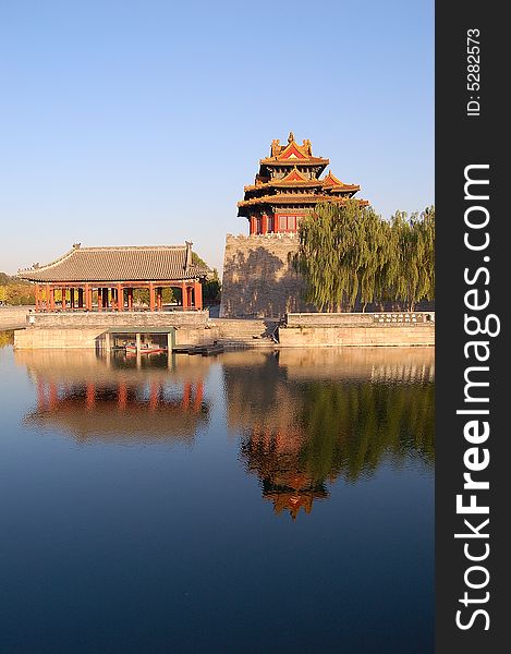 Turret, willows and their reflections on moat in the northwest corner of forbidden city, Beijing China. Turret, willows and their reflections on moat in the northwest corner of forbidden city, Beijing China.