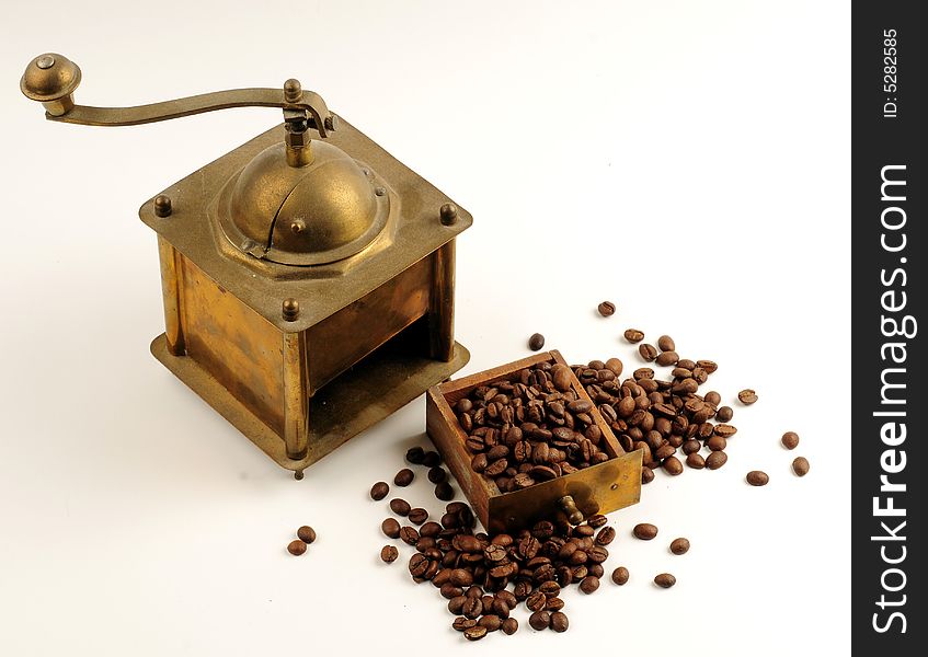 Antiquity coffee machine with beans over white