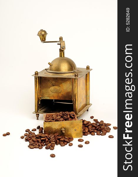 Antiquity coffee machine with beans over white