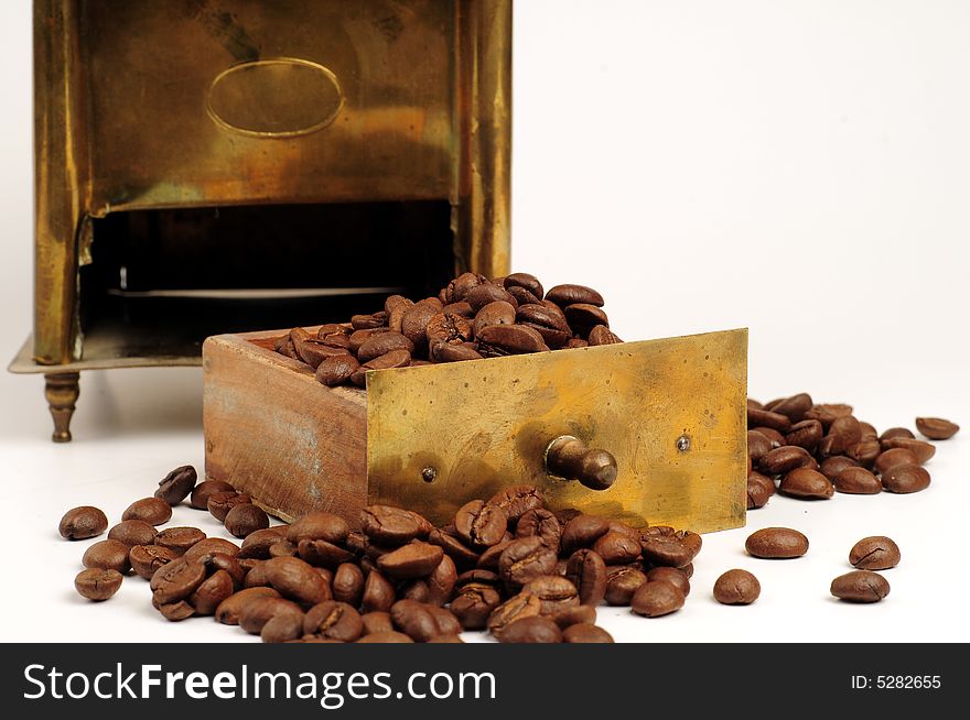 Antiquity coffee machine with beans over white